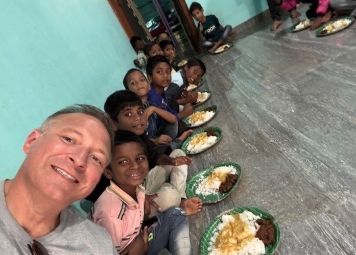 Ryan eating with the children